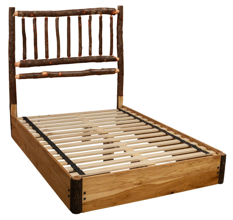 Angled view of the Mount Oxford Hickory Log Platform Bed showing the hickory spindle headboard and slatted hardwood platform