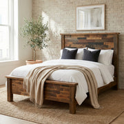Mount Princeton Reclaimed Barnwood Bed with navy pillows and a cream throw in a bright bedroom with a woven rug