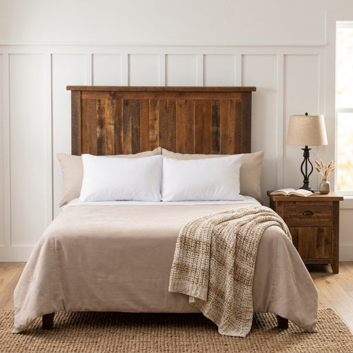 Mount Sherman Reclaimed Barnwood Headboard against white board and batten walls with a reclaimed wood nightstand and iron lamp