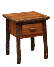 Angled view of the Mount Sniktau Hickory Log One Drawer Nightstand in Cognac showing the drawer and bark-on log legs