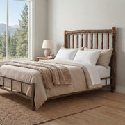 Mount Wilson Hickory Log Headboard with cream bedding beside a tall window overlooking pine trees and mountains