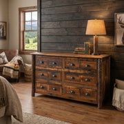 Mount Ypsilon Barnwood and Hickory Dresser with a lamp beside a dark shiplap accent wall in a cabin bedroom