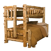 Mount Zirkel Cedar Log Bunk Bed in Twin over Full configuration with tan bedding and spindle guard rails