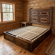 Obstruction Point Reclaimed Barnwood Framed Panel Platform Bed staged in a sunlit log cabin bedroom