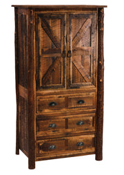 Angled view of the Otis Peak Barnwood and Hickory Armoire showing barn-door cabinet doors and hickory log posts