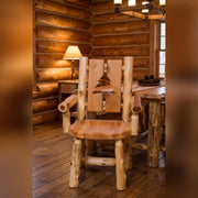 Parika Peak Cedar Log Cutout Dining Arm Chair in a warmly lit log cabin dining room