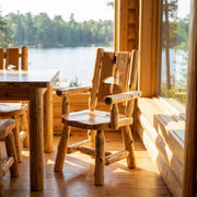 Parika Peak Cedar Log Cutout Dining Arm Chair with a loon cutout in a lake cabin dining room