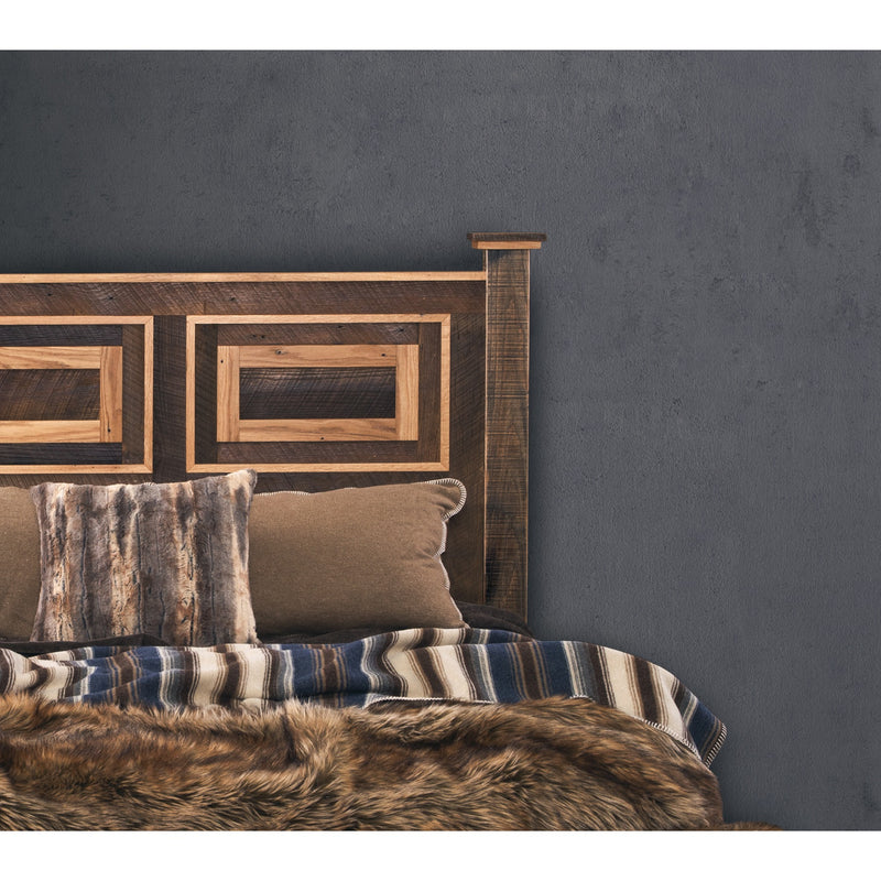 Peak One Reclaimed Barnwood Framed Panel Headboard behind a bed with a faux fur throw