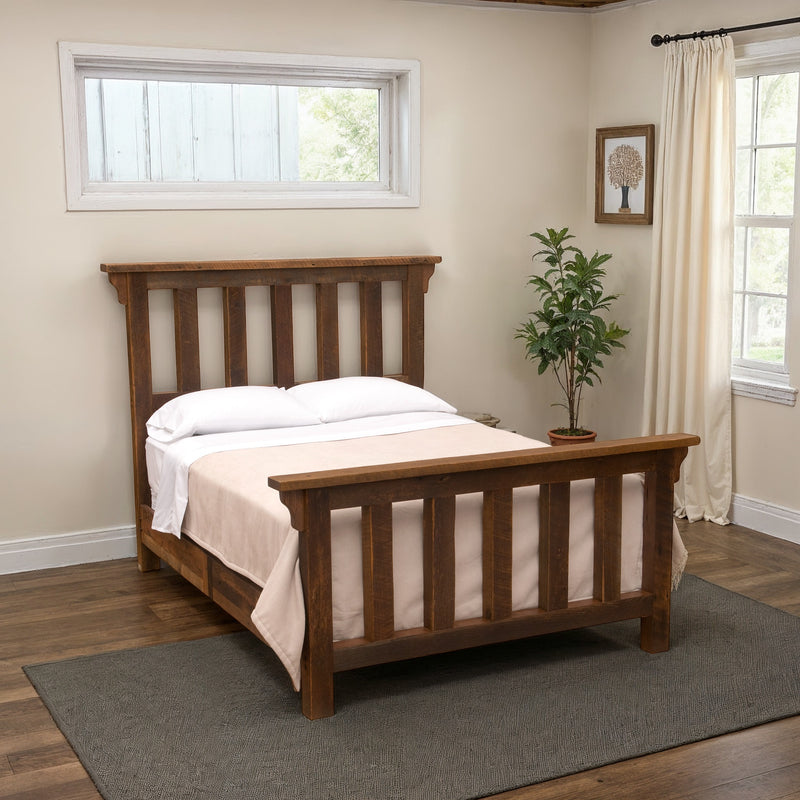 Pikes Peak Reclaimed Barnwood Post Bed with white bedding in a bright bedroom with a window and potted plant