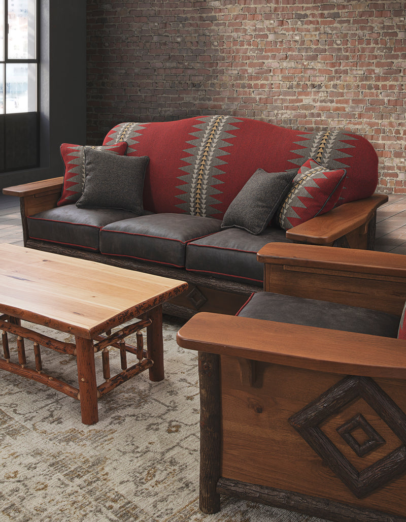 Pilot Knob Hickory Log Rectangle Coffee Table in front of a red sofa in a rustic living room
