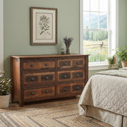 Pyramid Peak Reclaimed Barnwood Dresser beneath a framed botanical print beside a bed in a sage green bedroom