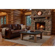 Red Peak Pine Square Coffee Table staged in a rustic log cabin living room with a stone fireplace