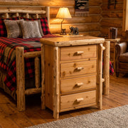 Redcloud Peak Cedar Log Four Drawer Chest staged in a log cabin bedroom beside a red plaid log bed