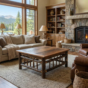 Rogers Peak Barnwood and Hickory Square Coffee Table in front of a sofa in a bright living room
