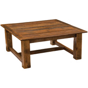 Angled view of the Rowe Peak Reclaimed Barnwood Square Coffee Table showing the planked top and square legs