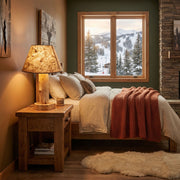 Sheep Mountain Cedar Log Table Lamp with burlap shade on a bedside table