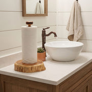 Freestanding Sleeping Sexton Cedar Log Paper Towel Holder on a kitchen counter