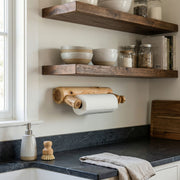 Wall-mounted Sleeping Sexton Cedar Log Paper Towel Holder in a rustic kitchen