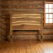 Star Peak Live Edge Walnut Headboard staged in a sunlit log cabin bedroom