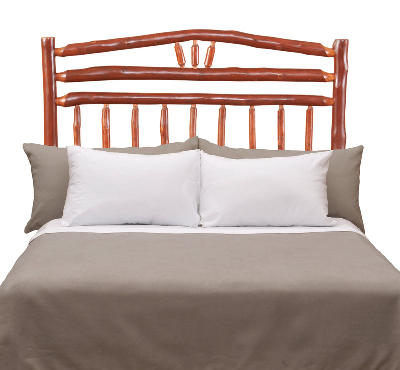 Front view of the Sunlight Peak Hickory Wagon Wheel Headboard styled with white pillows and gray bedding