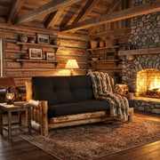 Tenmile Peak Cedar Log Futon staged in a log cabin living room beside a stone fireplace
