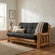 Tenmile Peak Cedar Log Futon in Natural with a black mattress and throw pillows in a bright living room