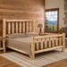 Angled view of the Timber Ridge Log Spindle Bed handcrafted from solid cedar logs in rustic room
