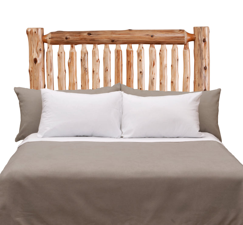 Front view of the Torreys Peak Cedar Log Spindle Headboard styled with white pillows and gray bedding