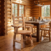 Trinity Peak Cedar Ladder Back Arm Chair staged in a sunlit log cabin dining room