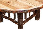 Close-up of the Vermillion Peak Hickory Log Round Coffee Table showing the hickory top edge and log legs
