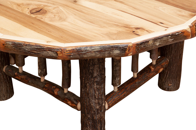 Close-up of the Vermillion Peak Hickory Log Round Coffee Table showing the hickory top edge and log legs