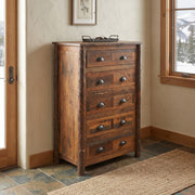 Vestal Peak Barnwood and Hickory Chest of Drawers with a vase on top near a window on a stone tile floor