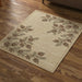 Beige rug with pine cone and branch pattern