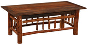 Angled view of the Woods Mountain Barnwood and Hickory Rectangle Coffee Table showing the planked top and hickory legs