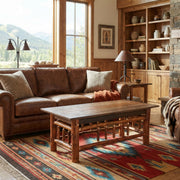 Woods Mountain Barnwood and Hickory Rectangle Coffee Table in front of a sofa in a sunny living room