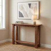 Ypsilon Mountain Reclaimed Barnwood Open Shelf Sofa Table with a lamp and framed art in a bright entryway