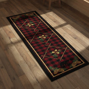 A vertical rectangular runner rug with a red and black buffalo plaid pattern, decorated with pine branches, pinecones, acorns, and black bear silhouettes at the top and bottom.